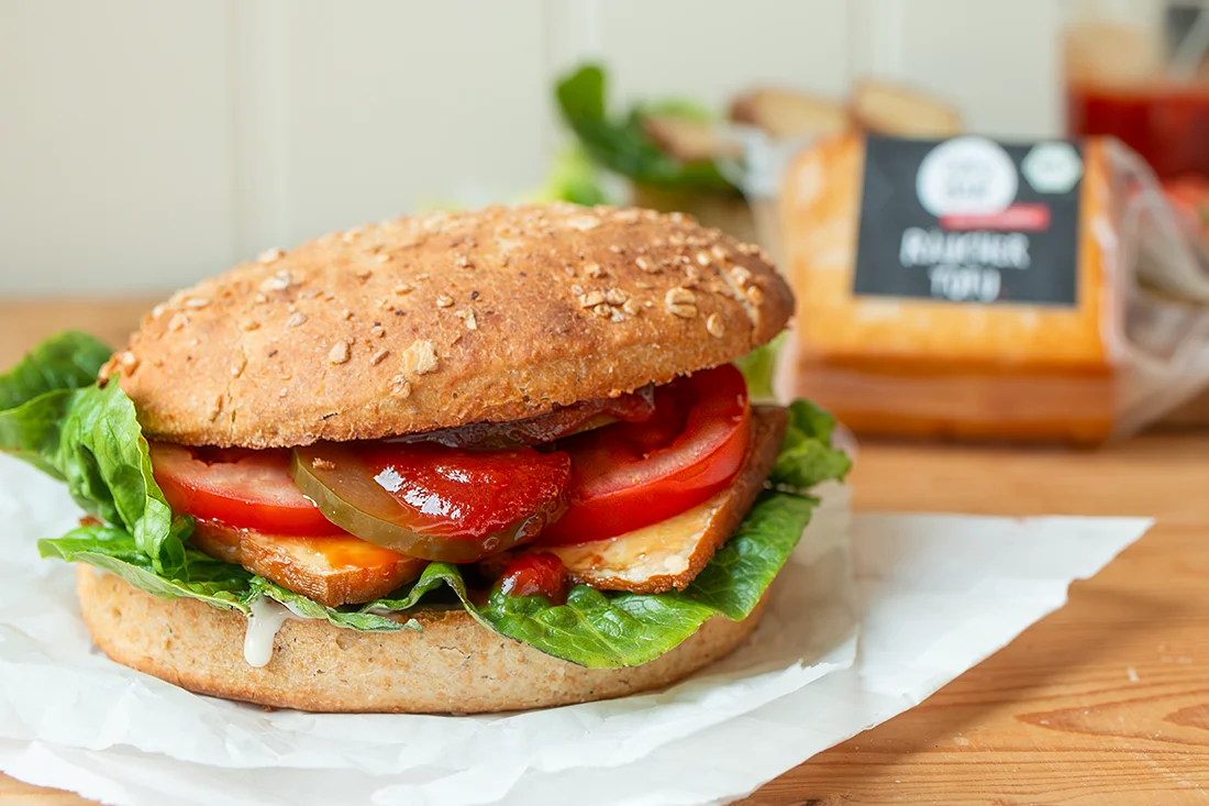 Burger mit Räuchertofu und BBQ Sauce auf einem Brett